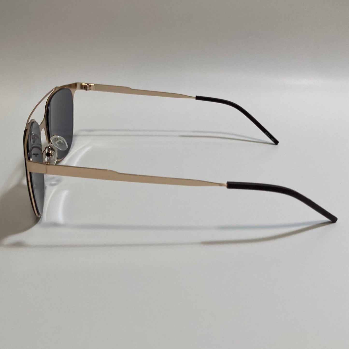 Square gold crossbar sunglasses with black lenses