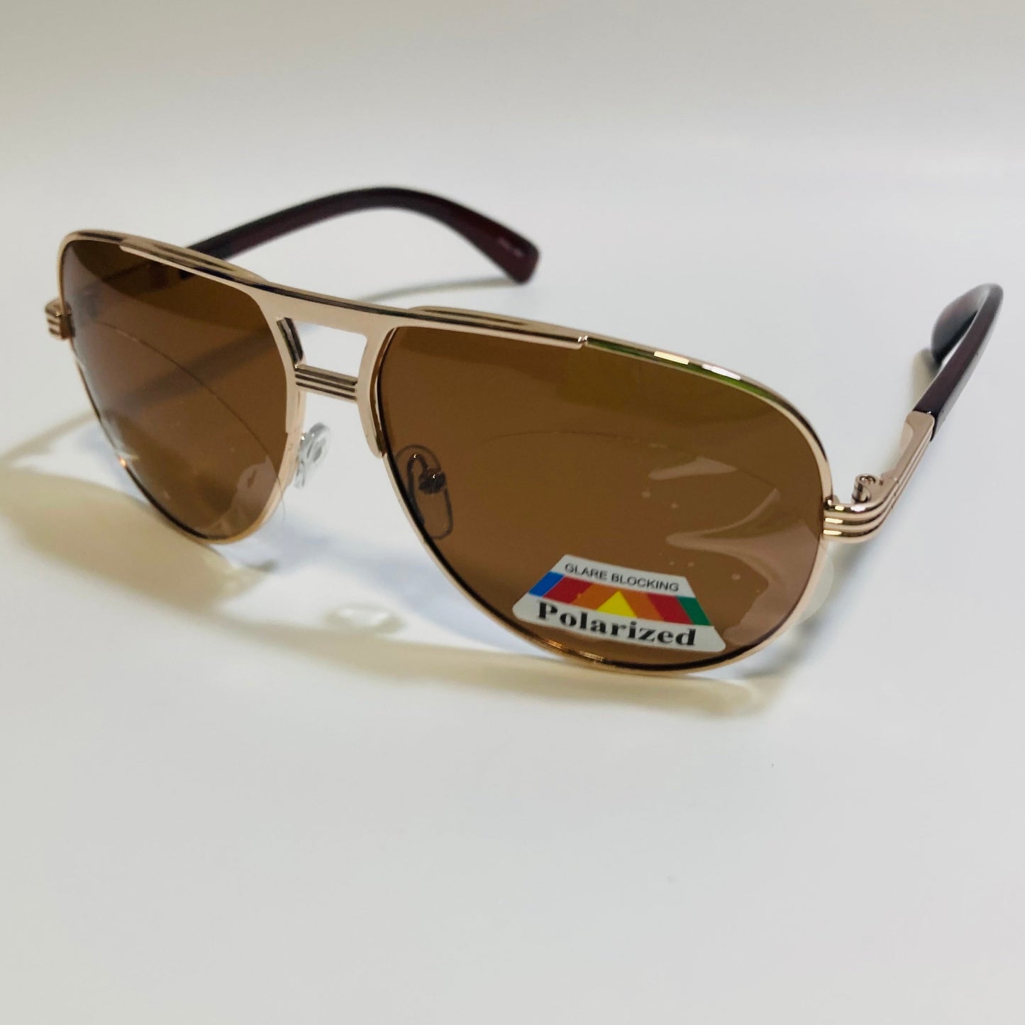 Polarized gold and brown aviator sunglasses with engraved metal frame