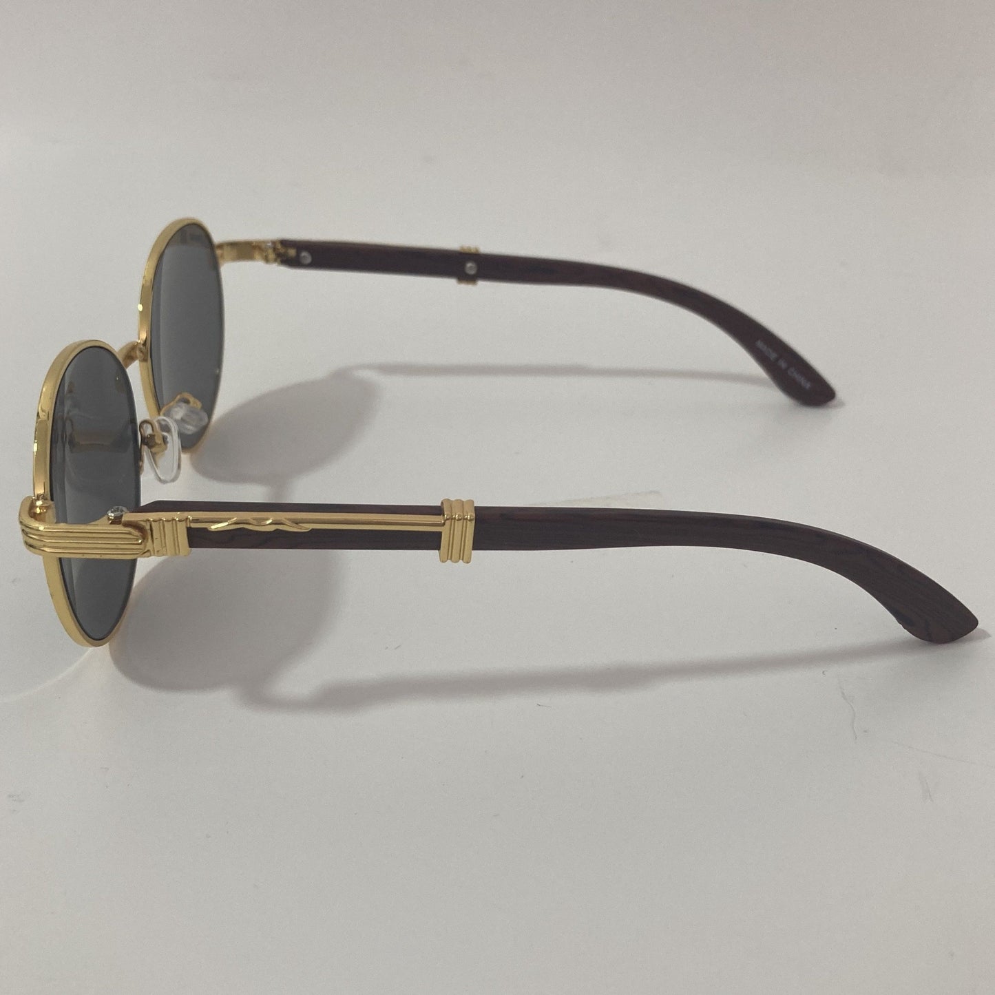 womens and mens gold and black round sunglasses