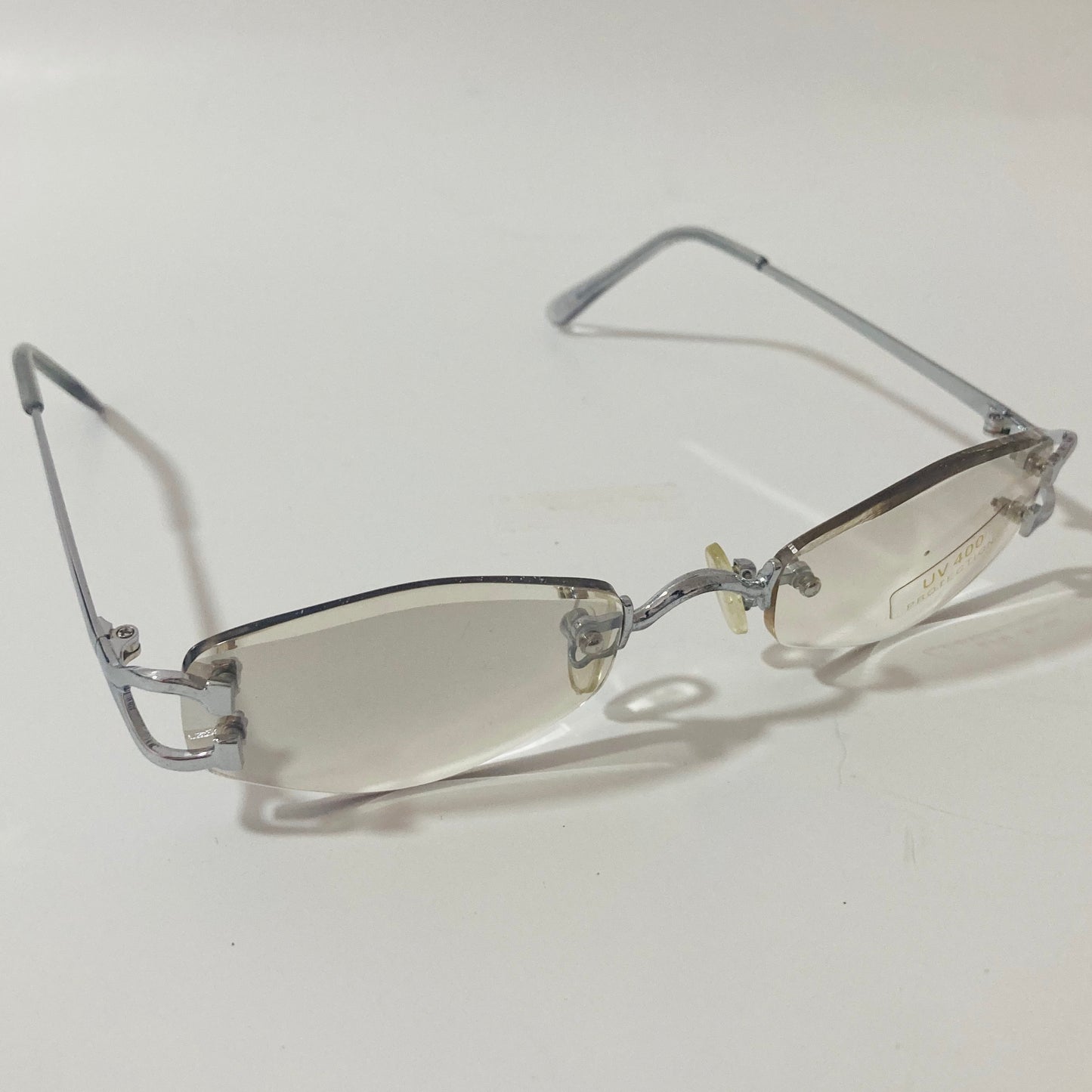 mens and womens silver and gray small rimless sunglasses