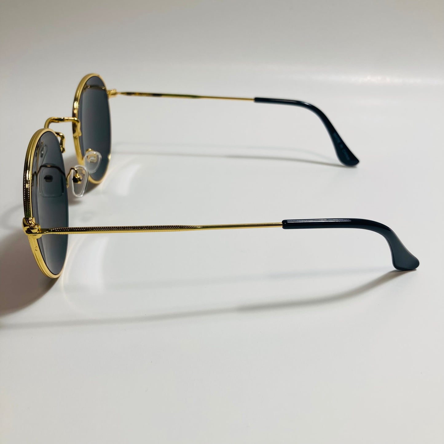 mens and womens round gold sunglasses with black lenses