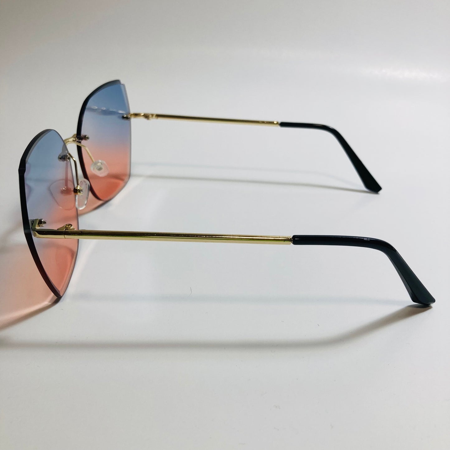 womens pink and blue oversize rimless sunglasses