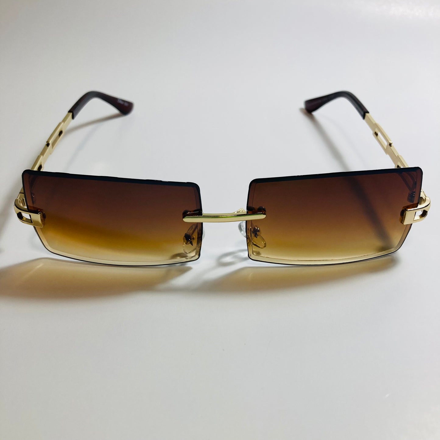 mens and womens brown and gold rimless square sunglasses