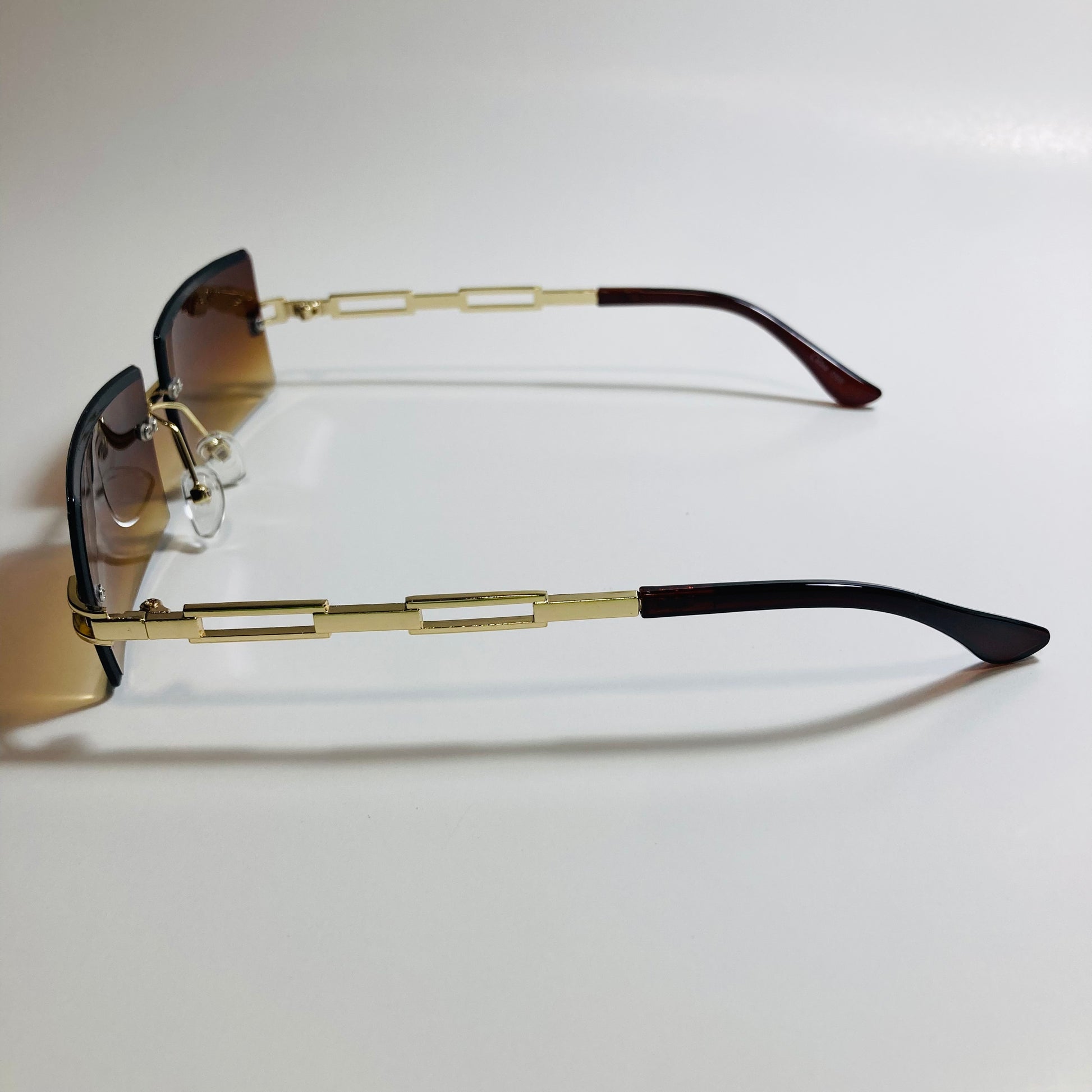 mens and womens brown and gold rimless square sunglasses