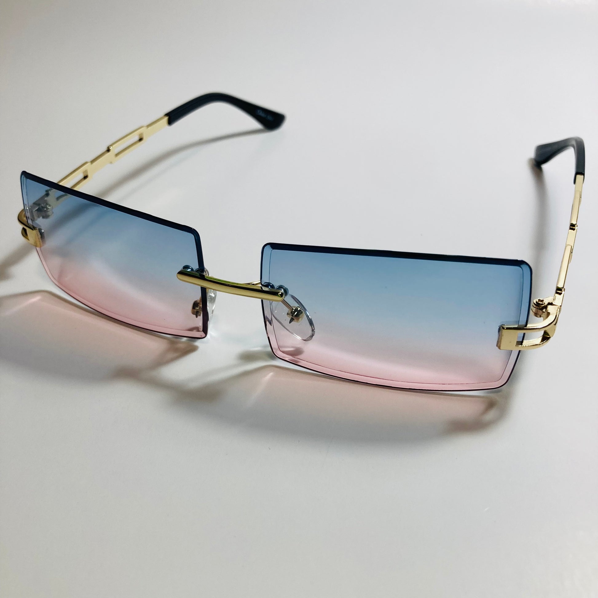 mens and womens pink blue and gold rimless square sunglasses
