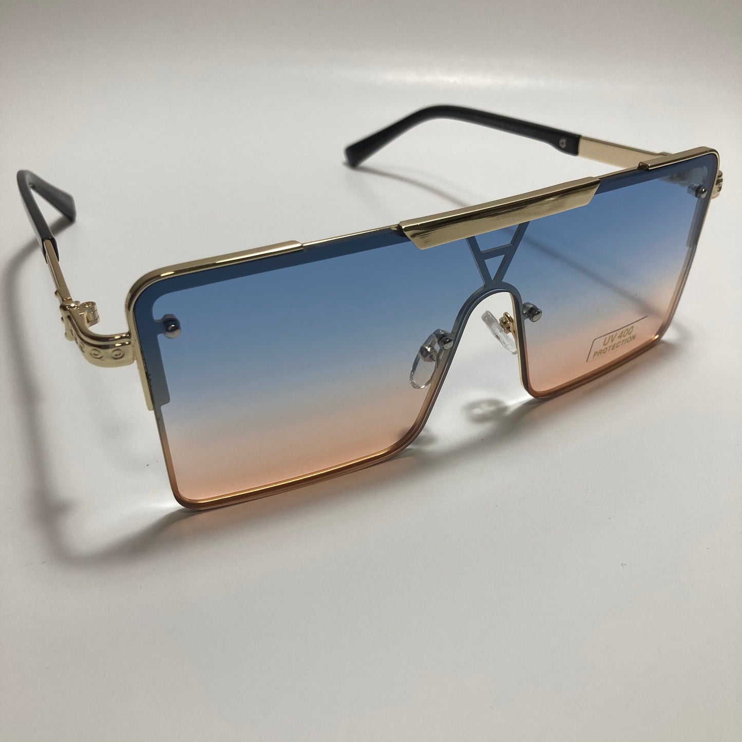 womens gold square oversize sunglasses with pink and blue lenses