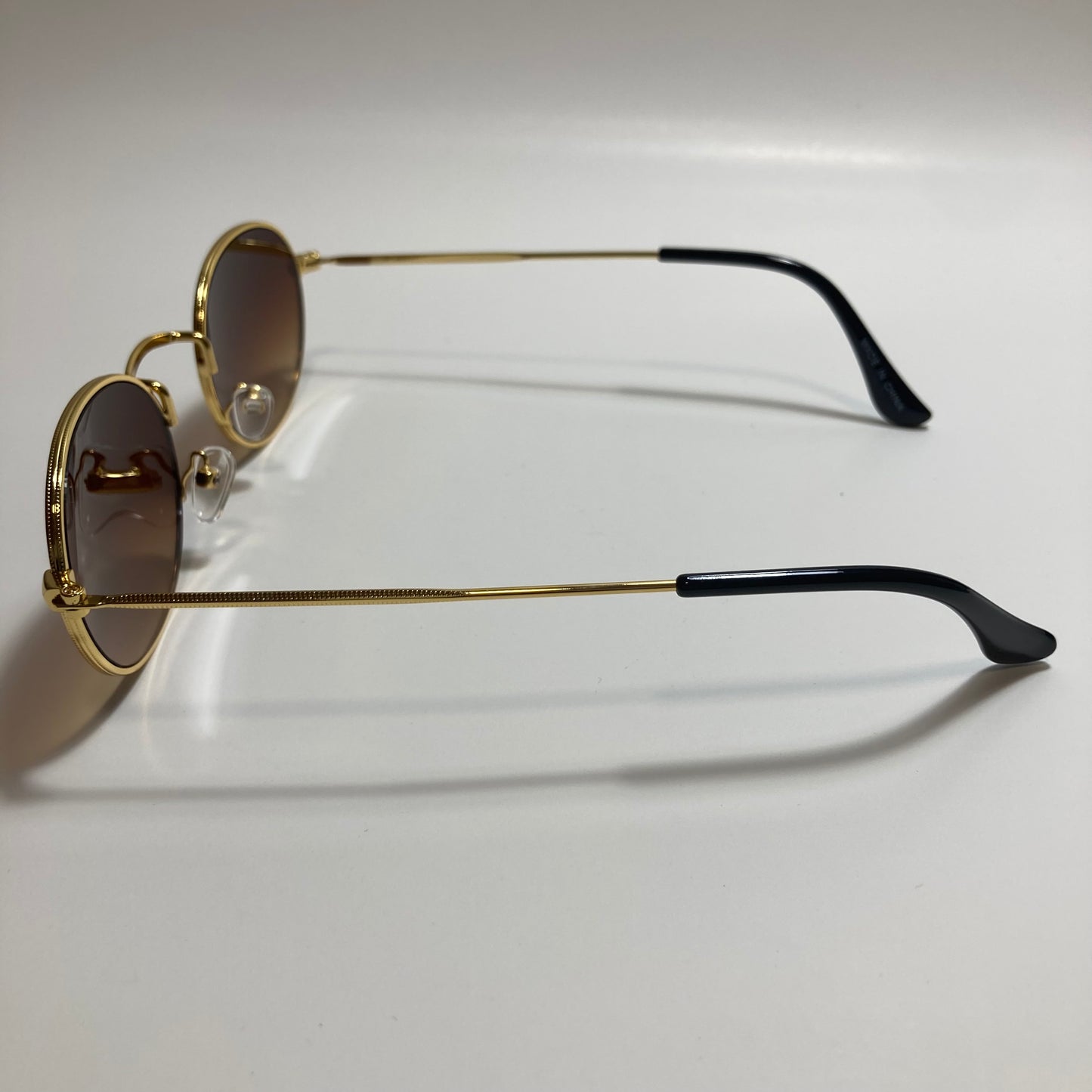 mens and womens small gold round sunglasses with brown lenses