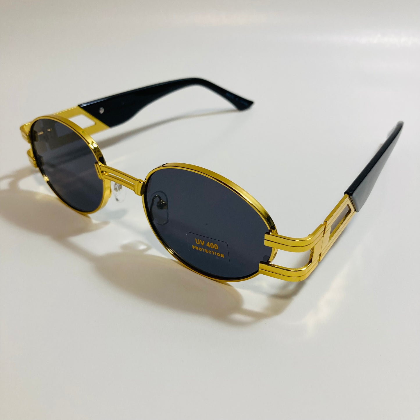 mens and womens gold and black round sunglasses