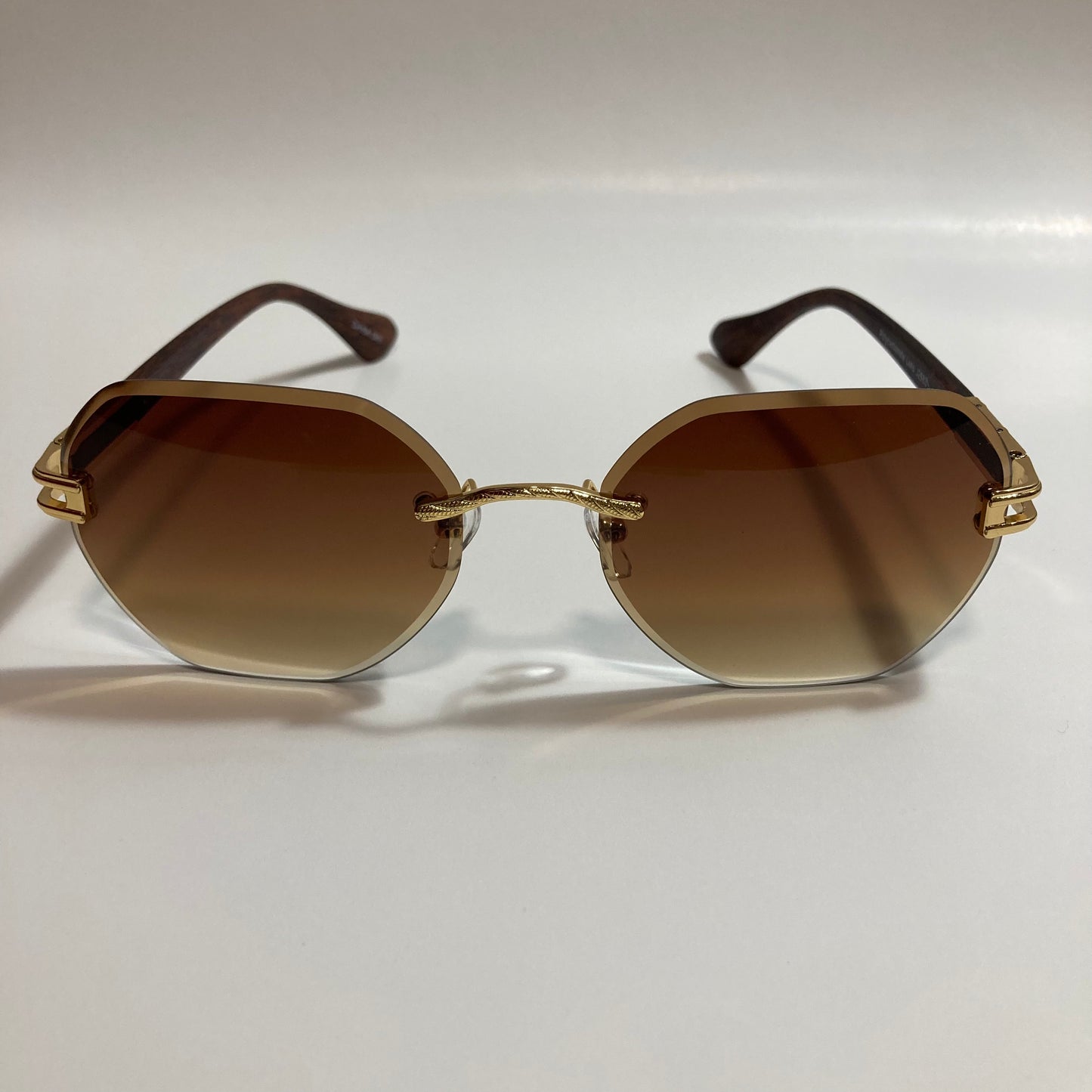 brown and gold rimless sunglasses
