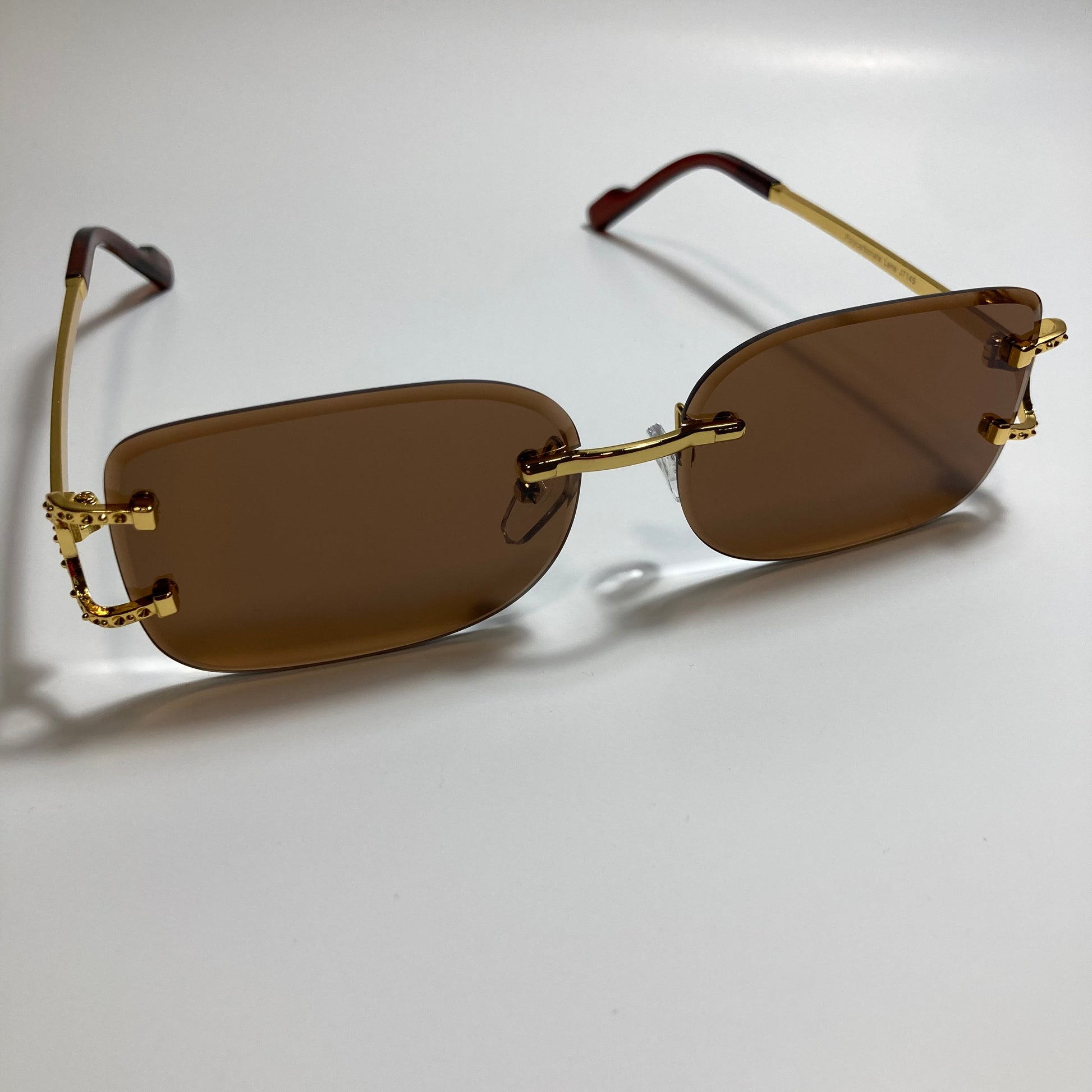mens and womens brown and gold rimless square sunglasses