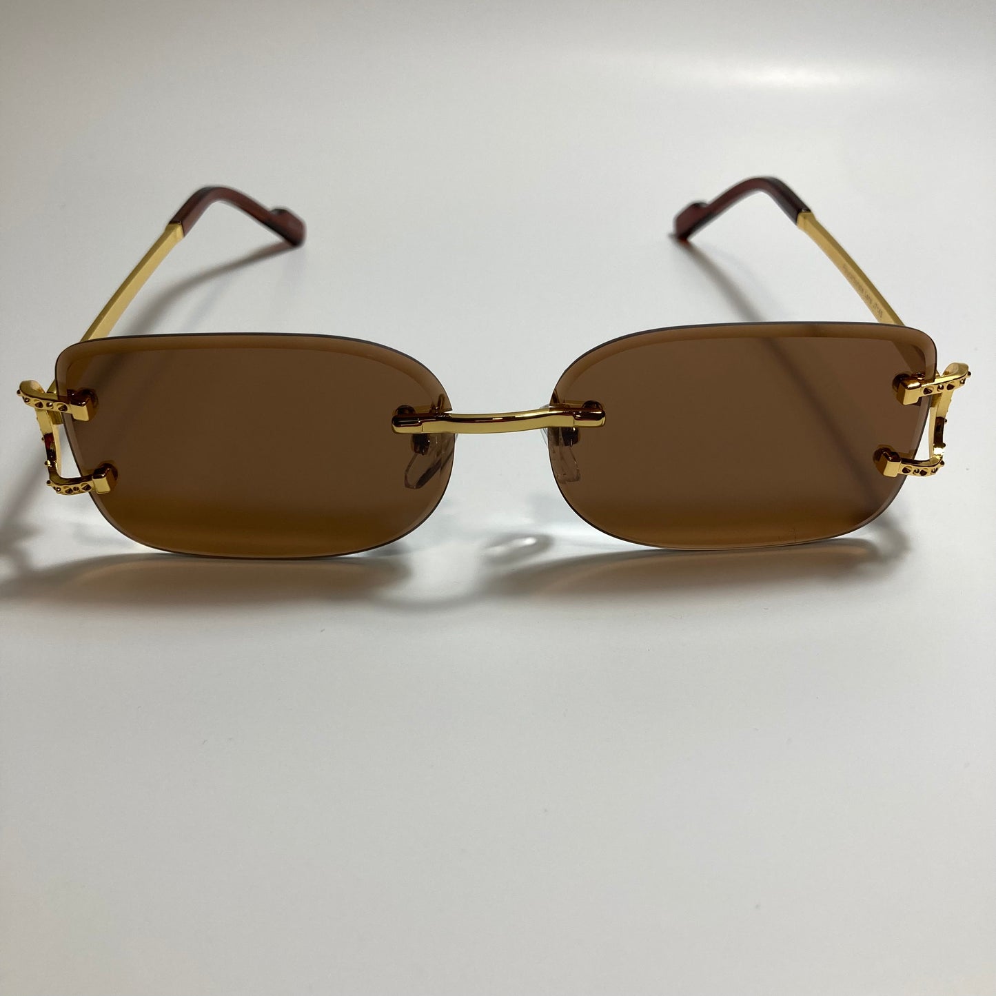 mens and womens brown and gold rimless square sunglasses