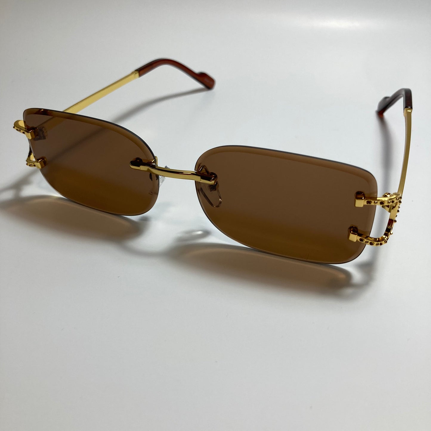 mens and womens brown and gold rimless square sunglasses