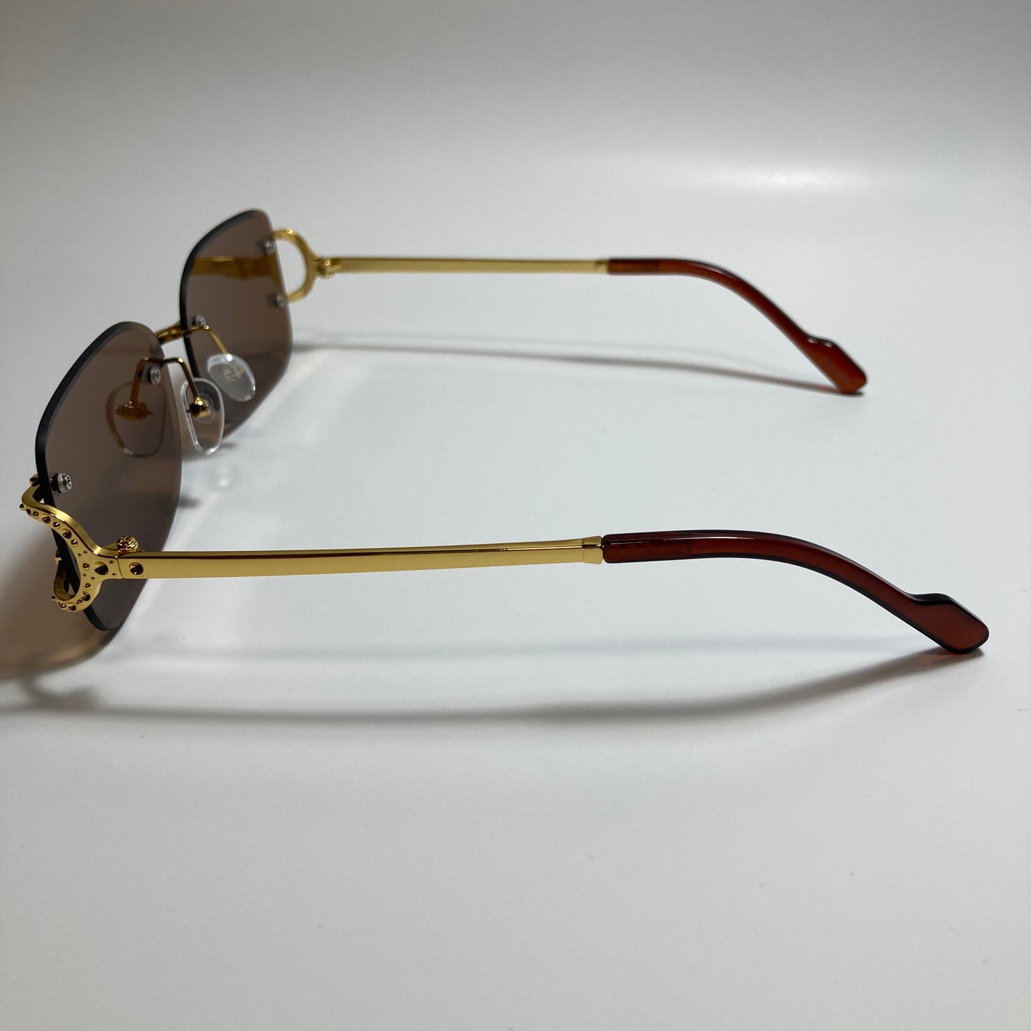 mens and womens brown and gold rimless square sunglasses
