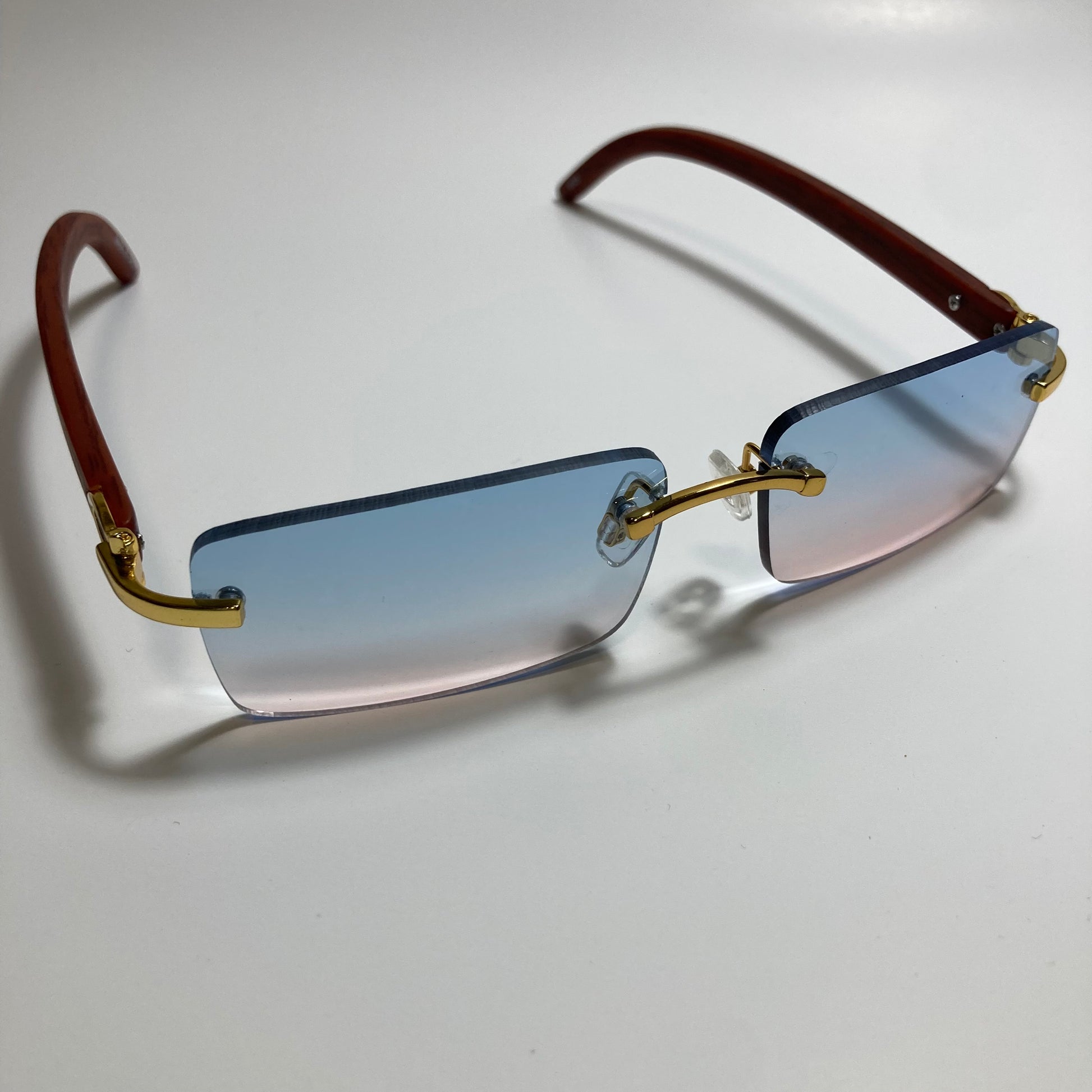 mens and womens pink and blue rimless square sunglasses