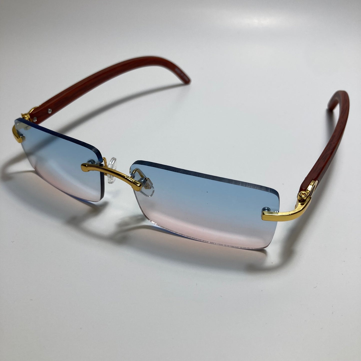 mens and womens pink and blue rimless square sunglasses