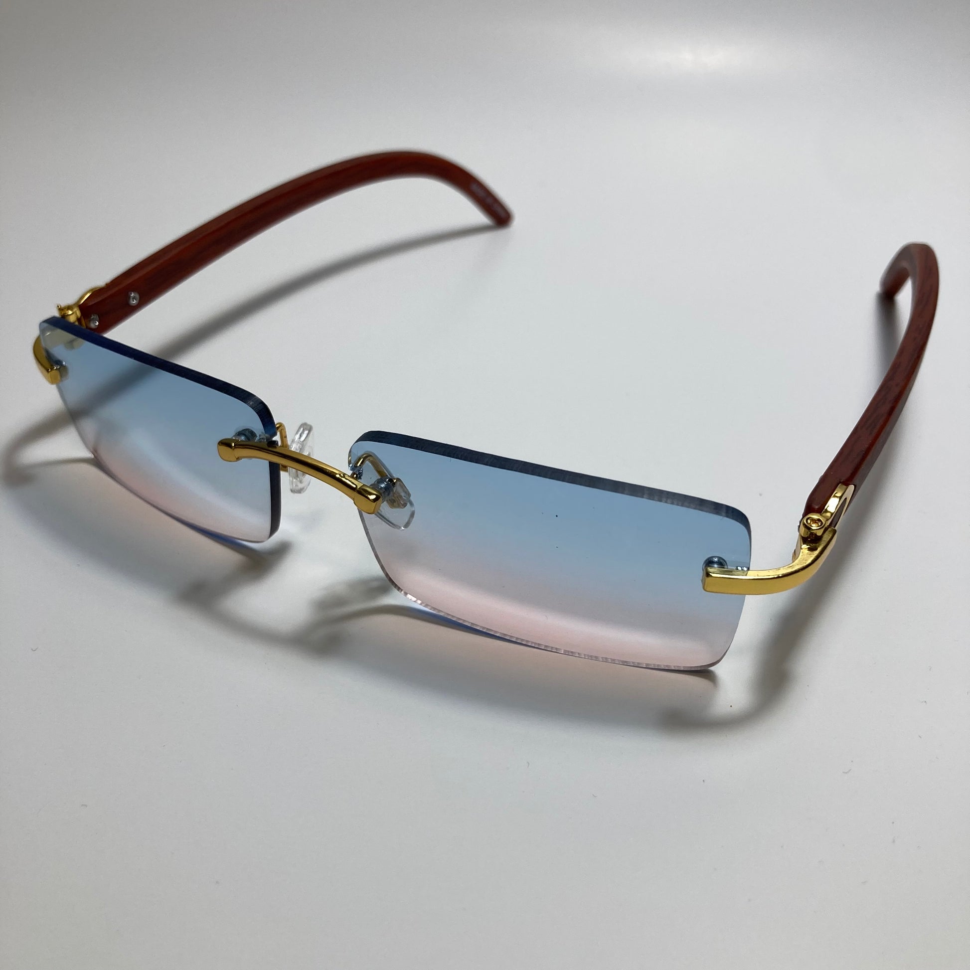mens and womens pink and blue rimless square sunglasses