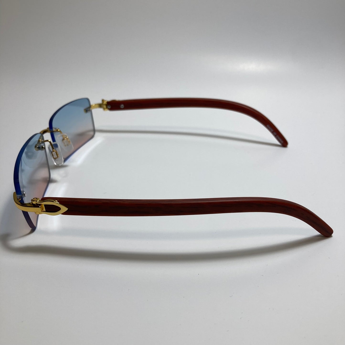 mens and womens pink and blue rimless square sunglasses