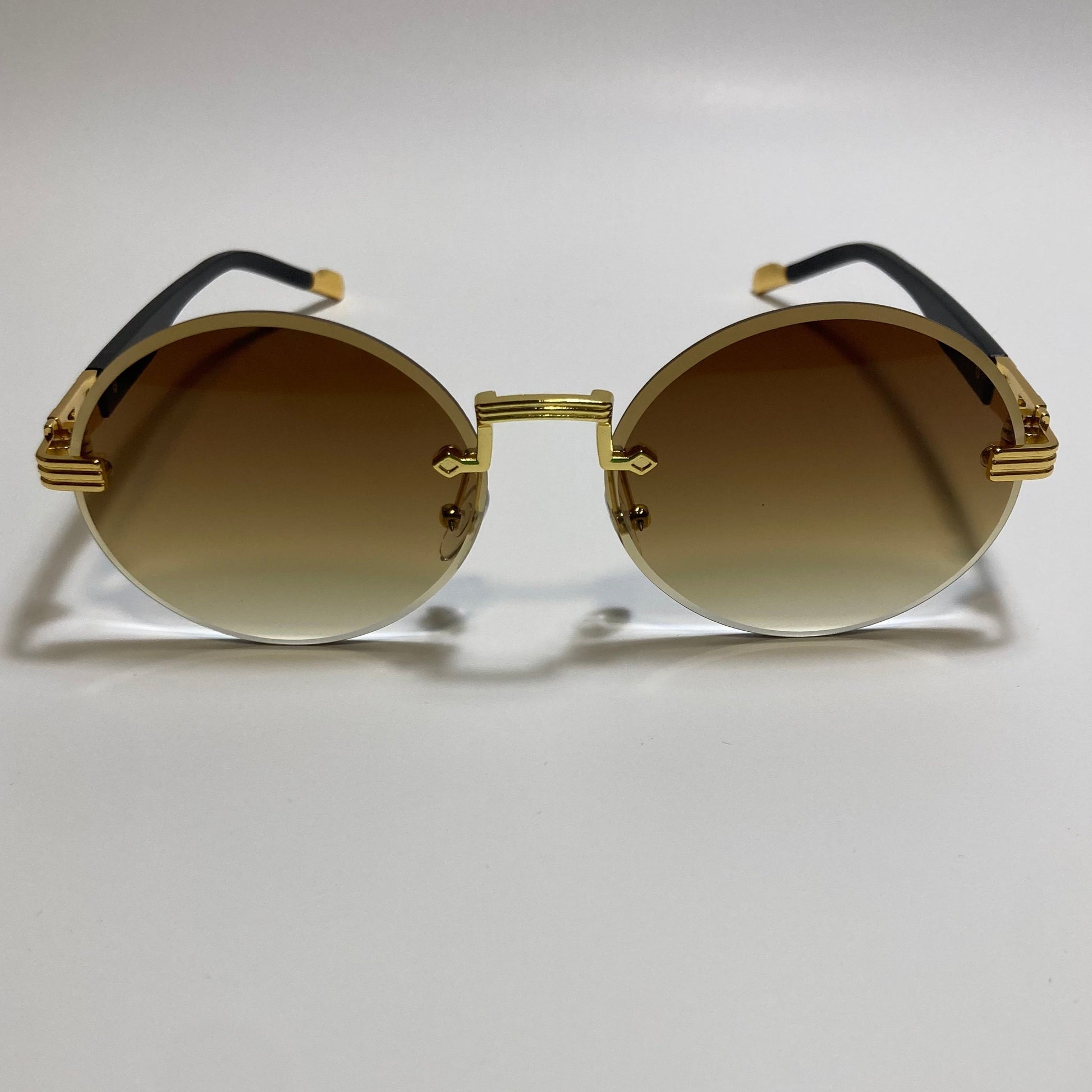 mens and womens rimless round glasses with brown lenses and gold frame 
