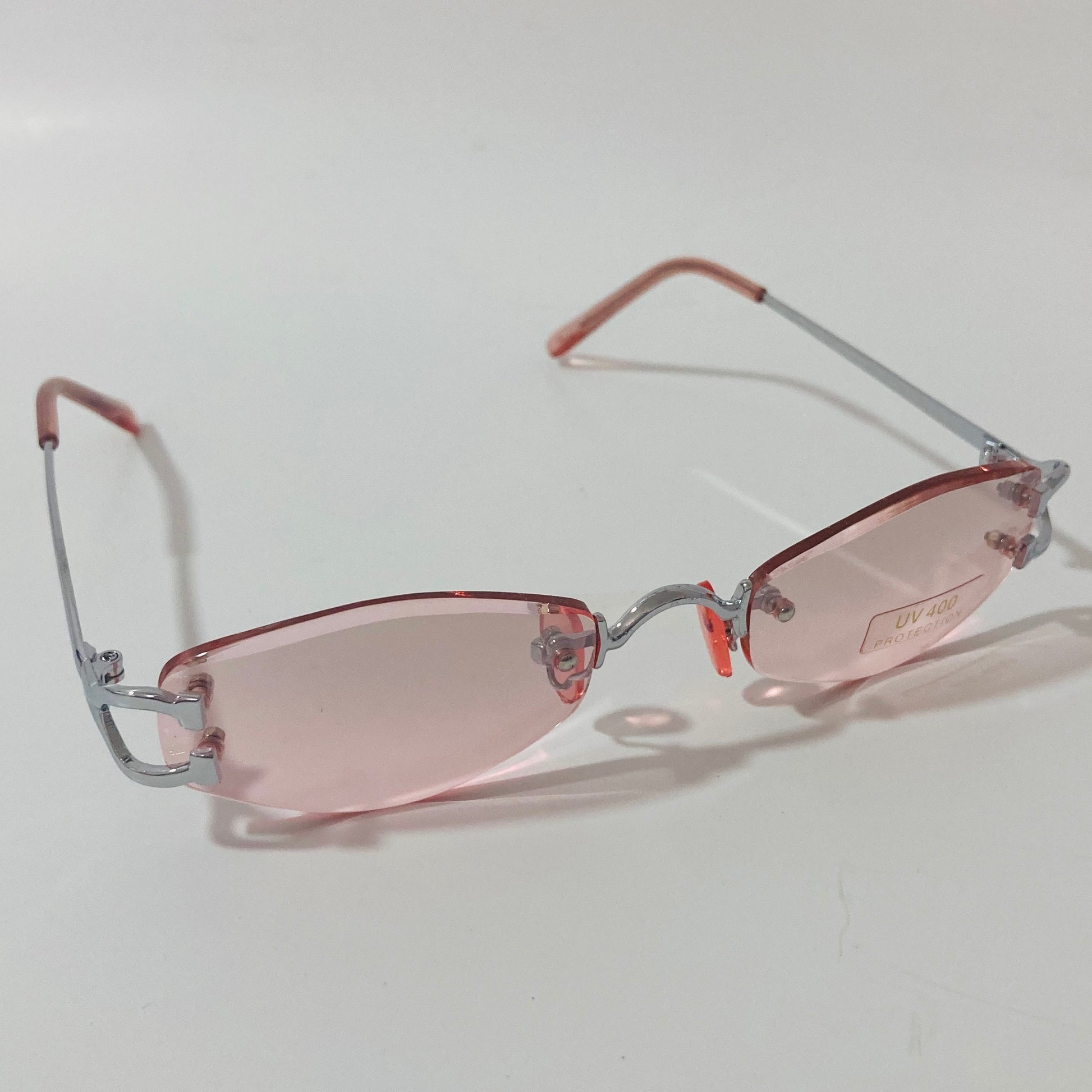 mens and womens silver and pink small rimless sunglasses