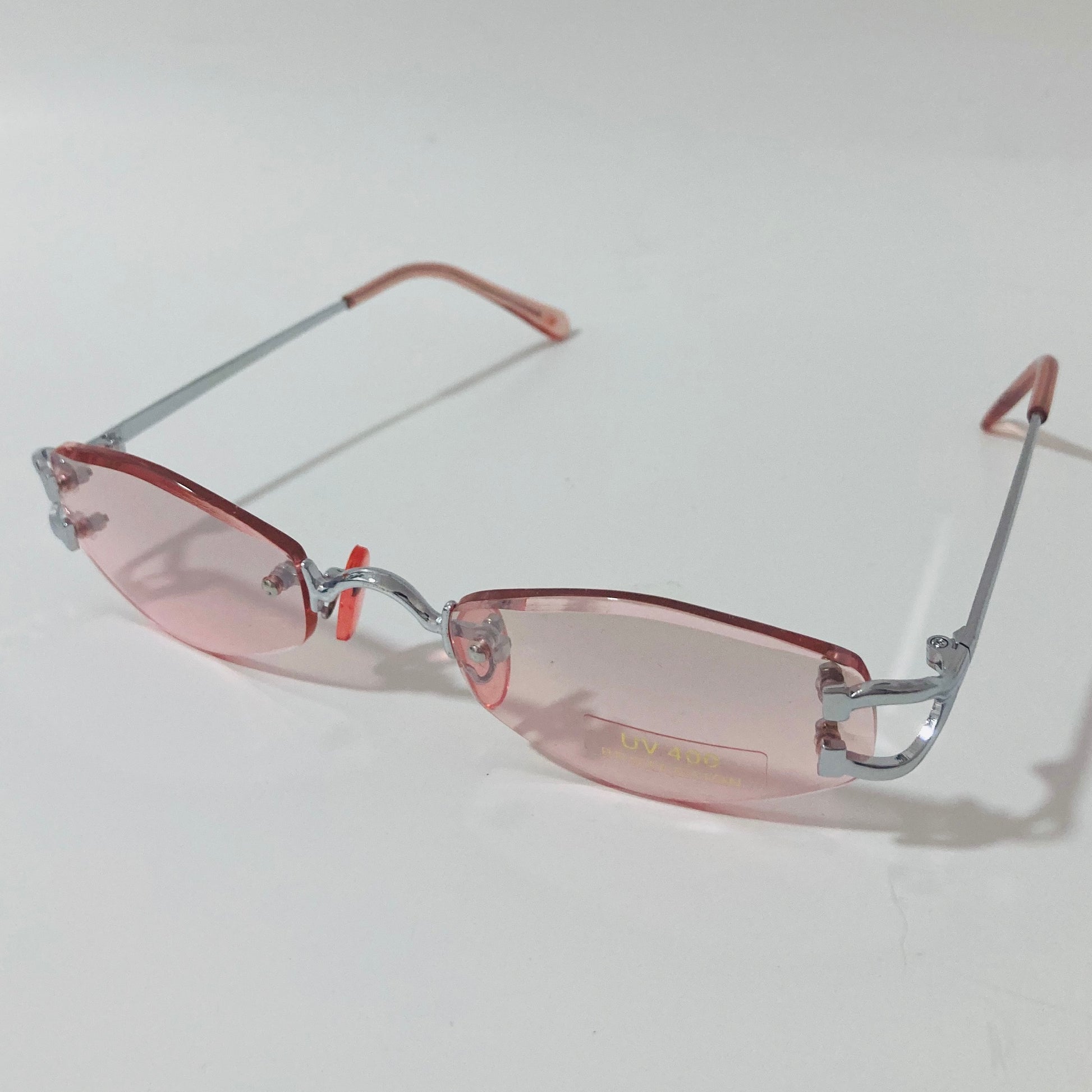 mens and womens silver and pink small rimless sunglasses