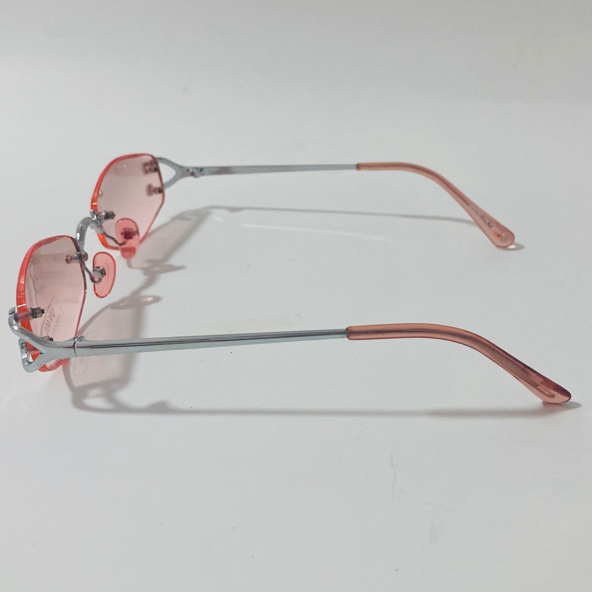 mens and womens silver and pink small rimless sunglasses