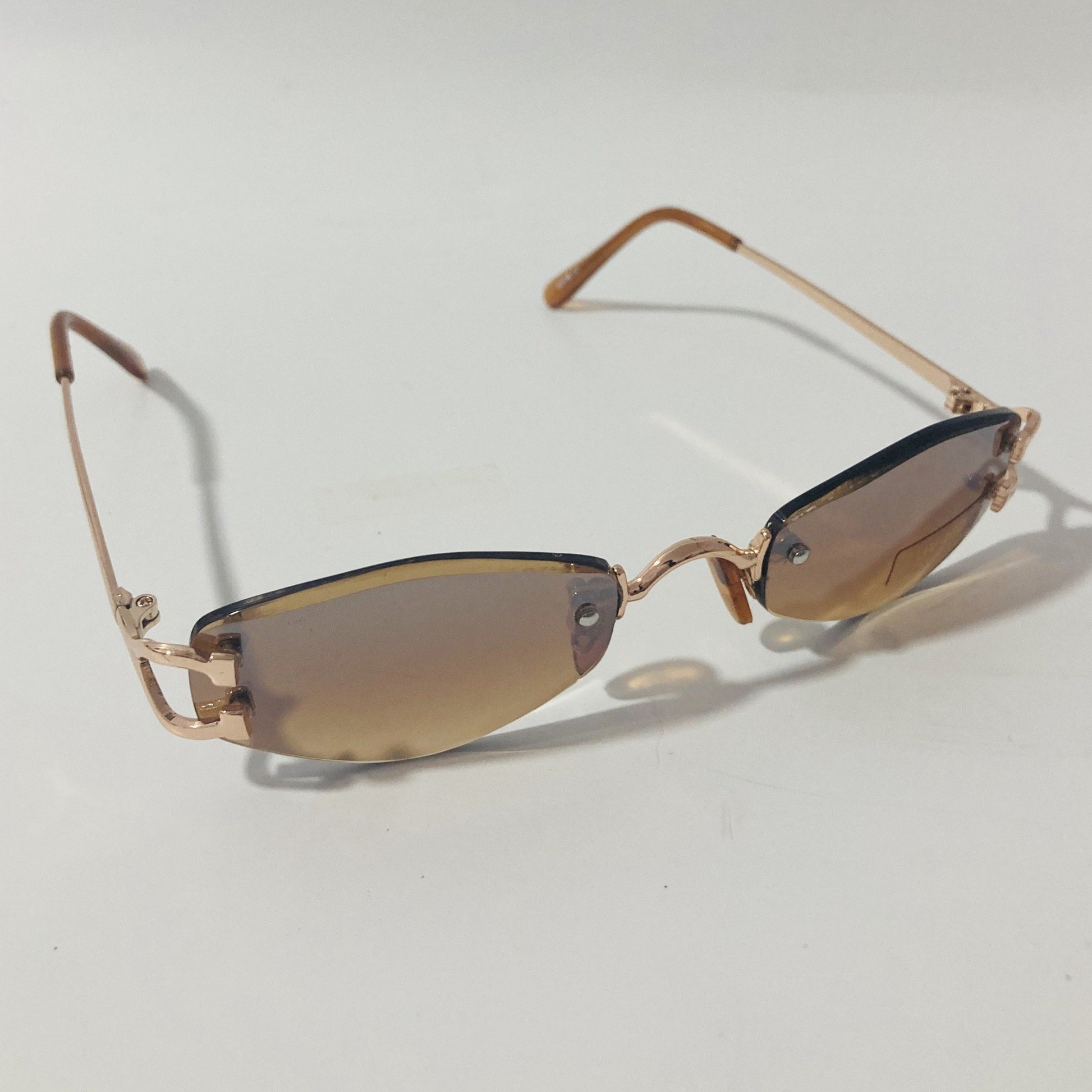 mens and womens brown and gold small rimless sunglasses