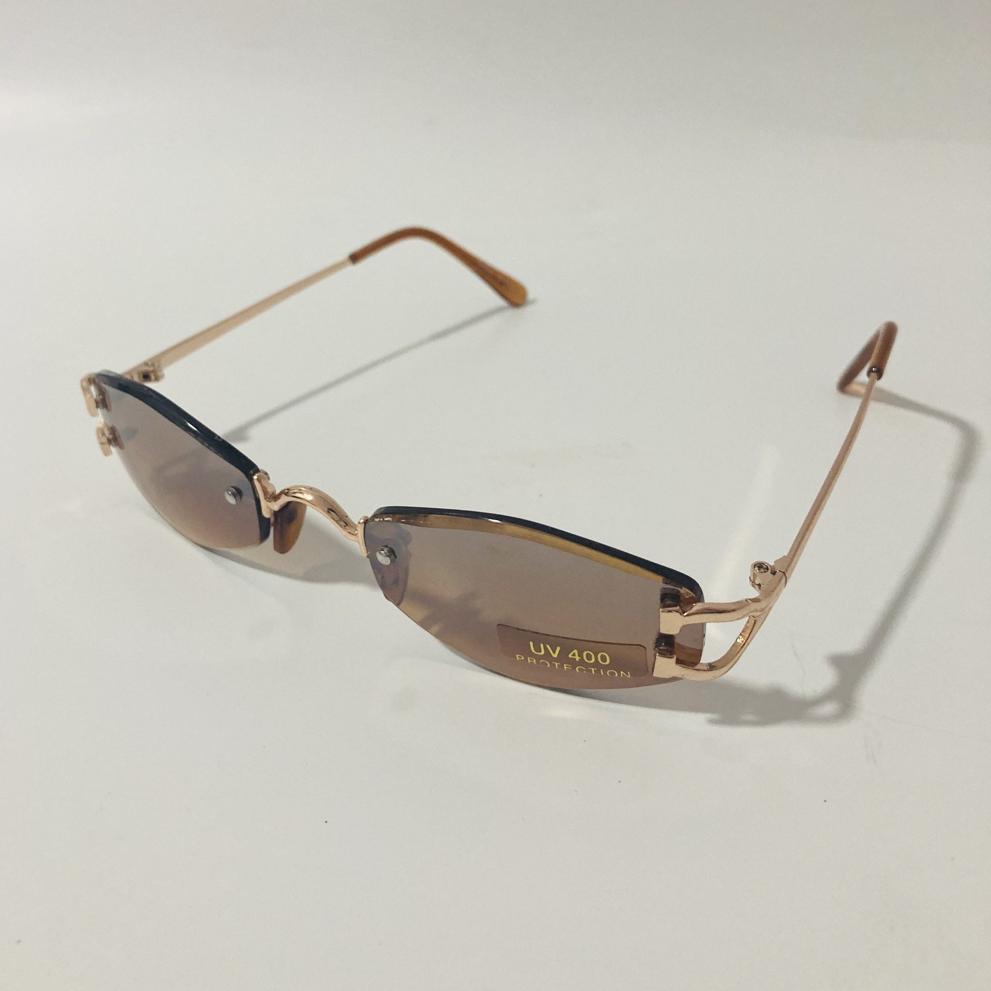 mens and womens brown and gold small rimless sunglasses
