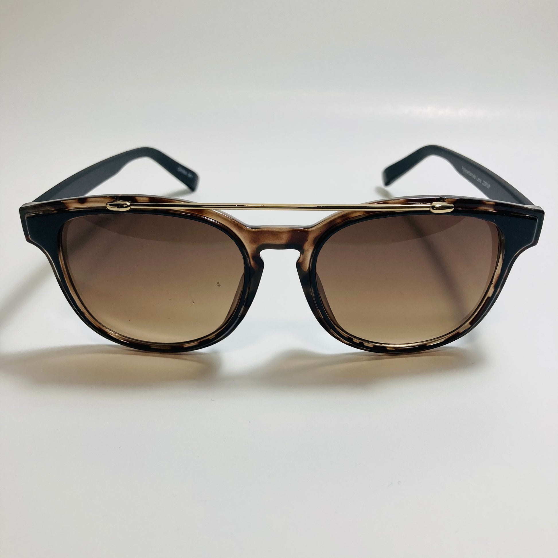 mens and womens brown and black round sunglasses with crossbar 