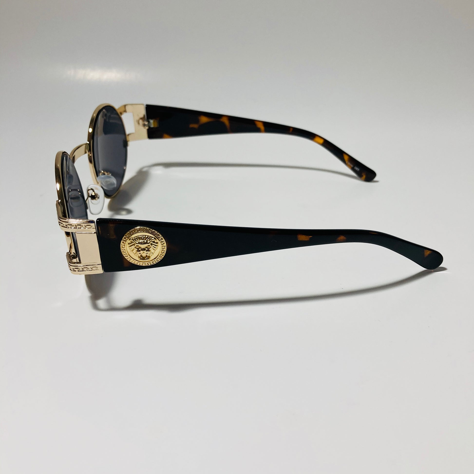 mens and womens black and gold round sunglasses