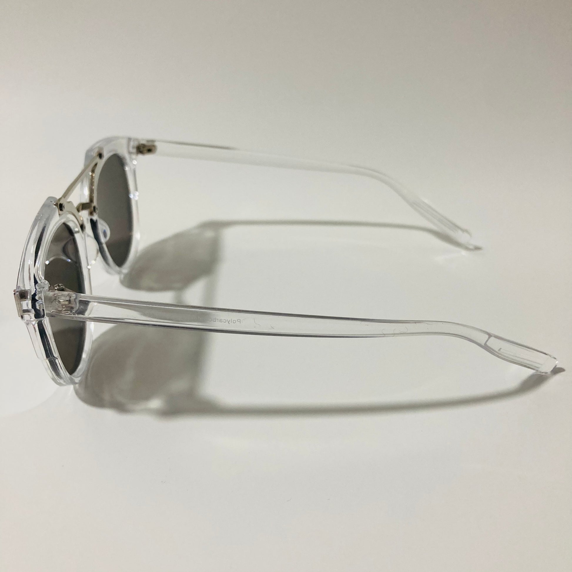 mens and womens clear silver and black round sunglasses with crossbar