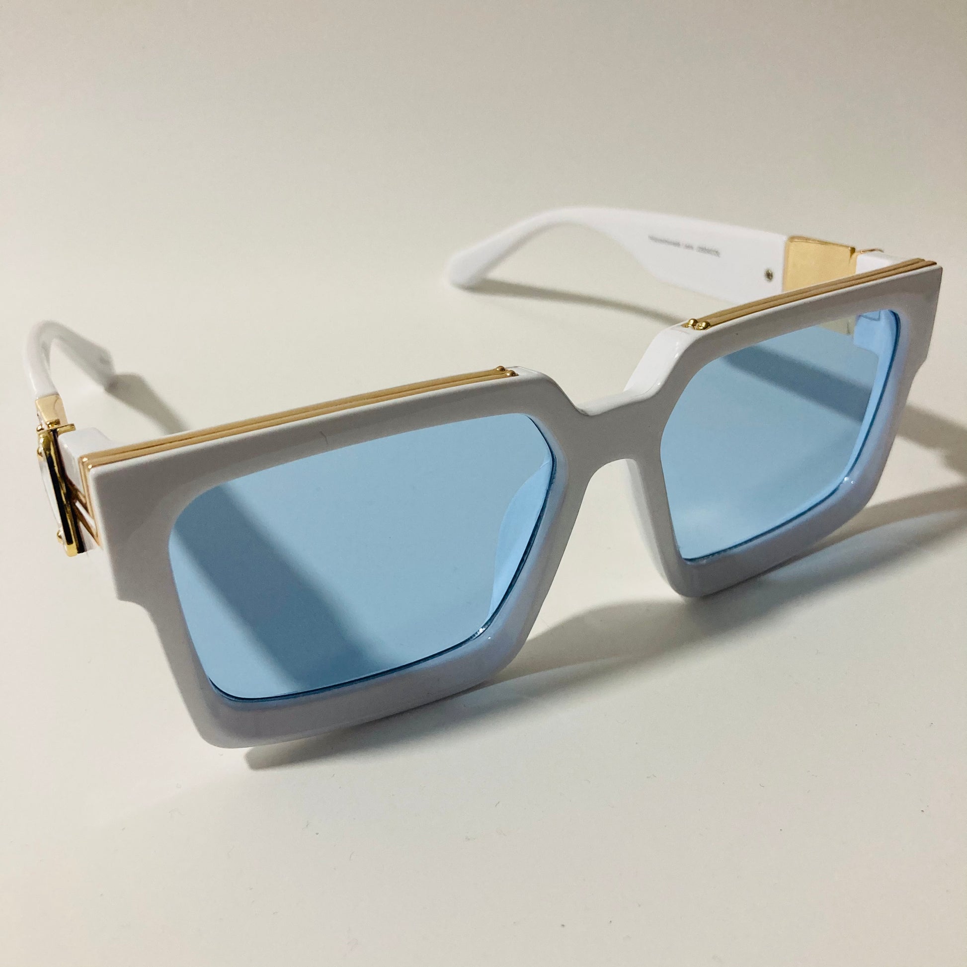 mens and womens white and blue square sunglasses with gold accents