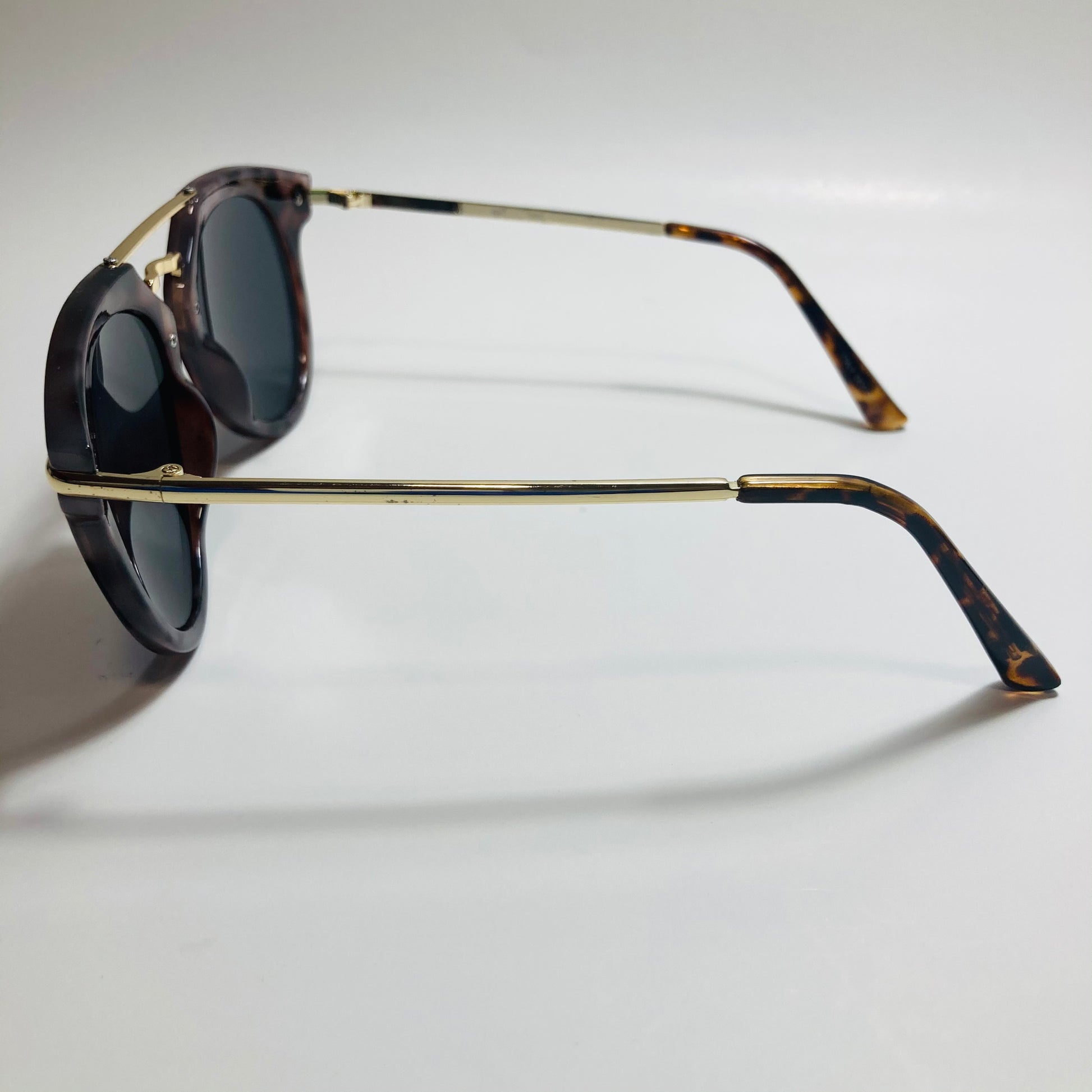 mens and womens black gold and brown mirrored round sunglasses with crossbar