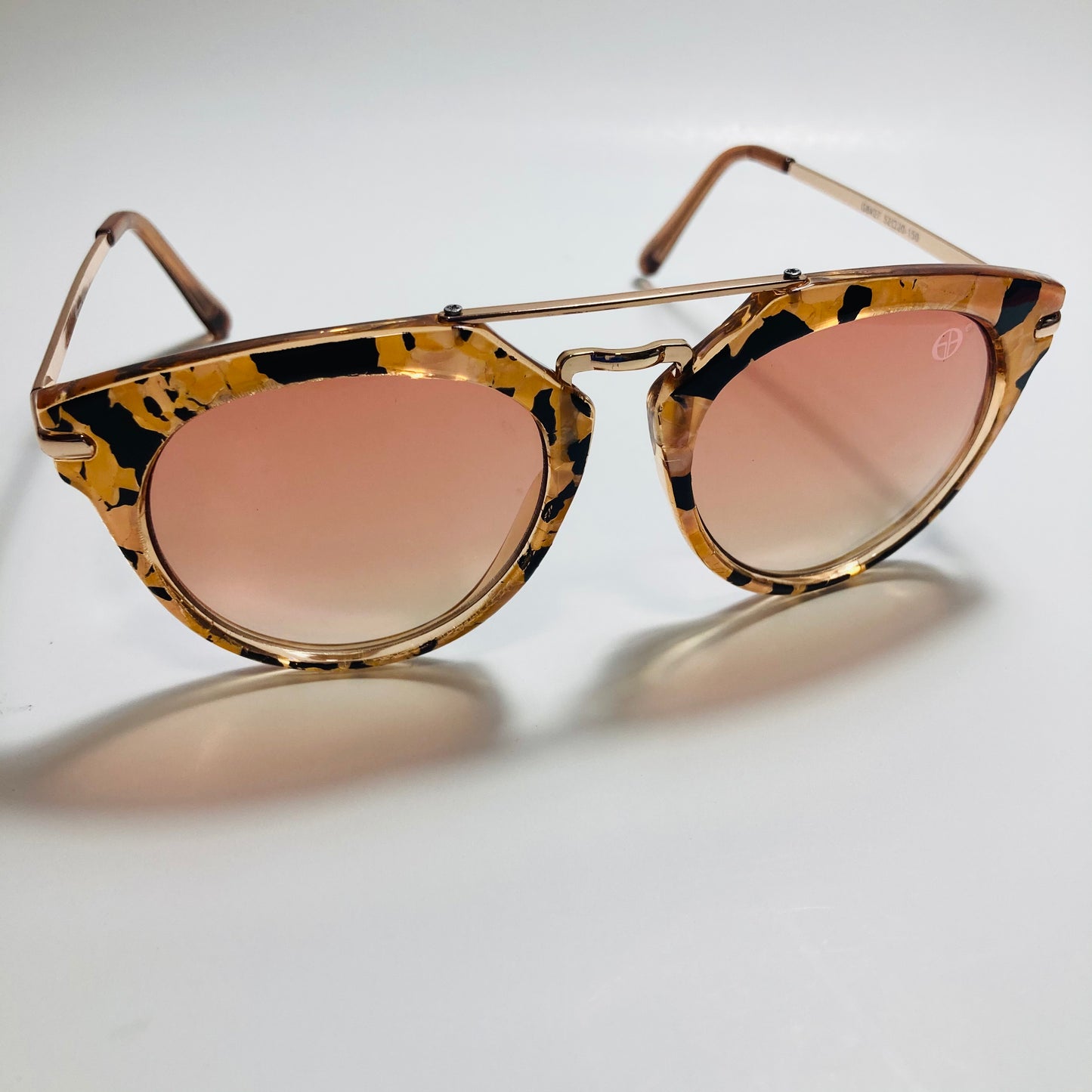 womens pink and gold round sunglasses with crossbar