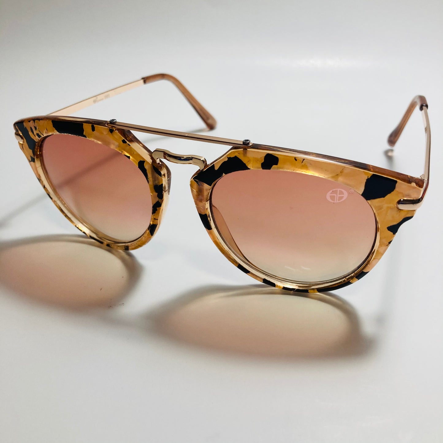 womens pink and gold round sunglasses with crossbar