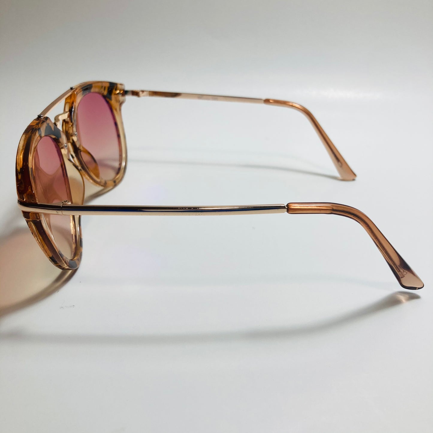 womens pink and gold round sunglasses with crossbar