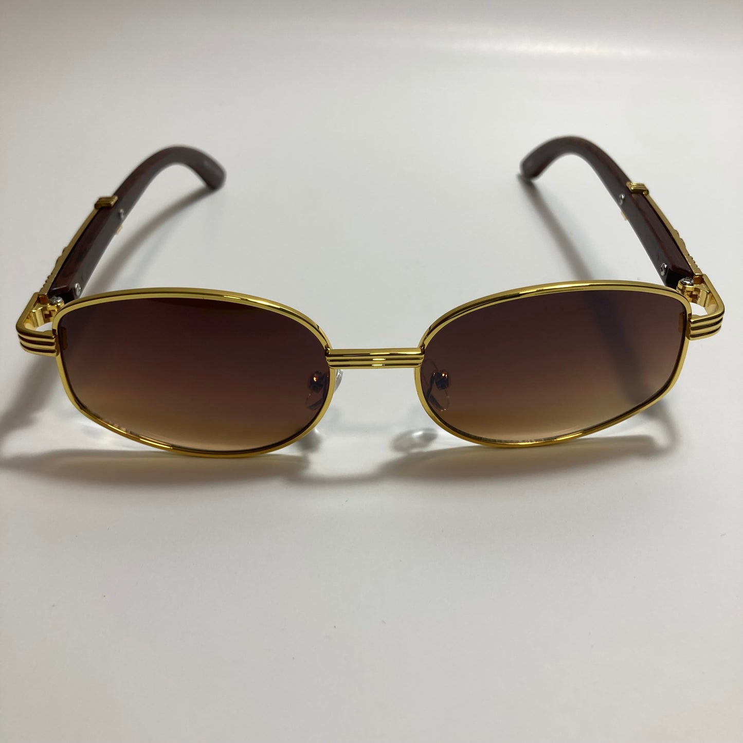 mens and womens brown and gold oval sunglasses