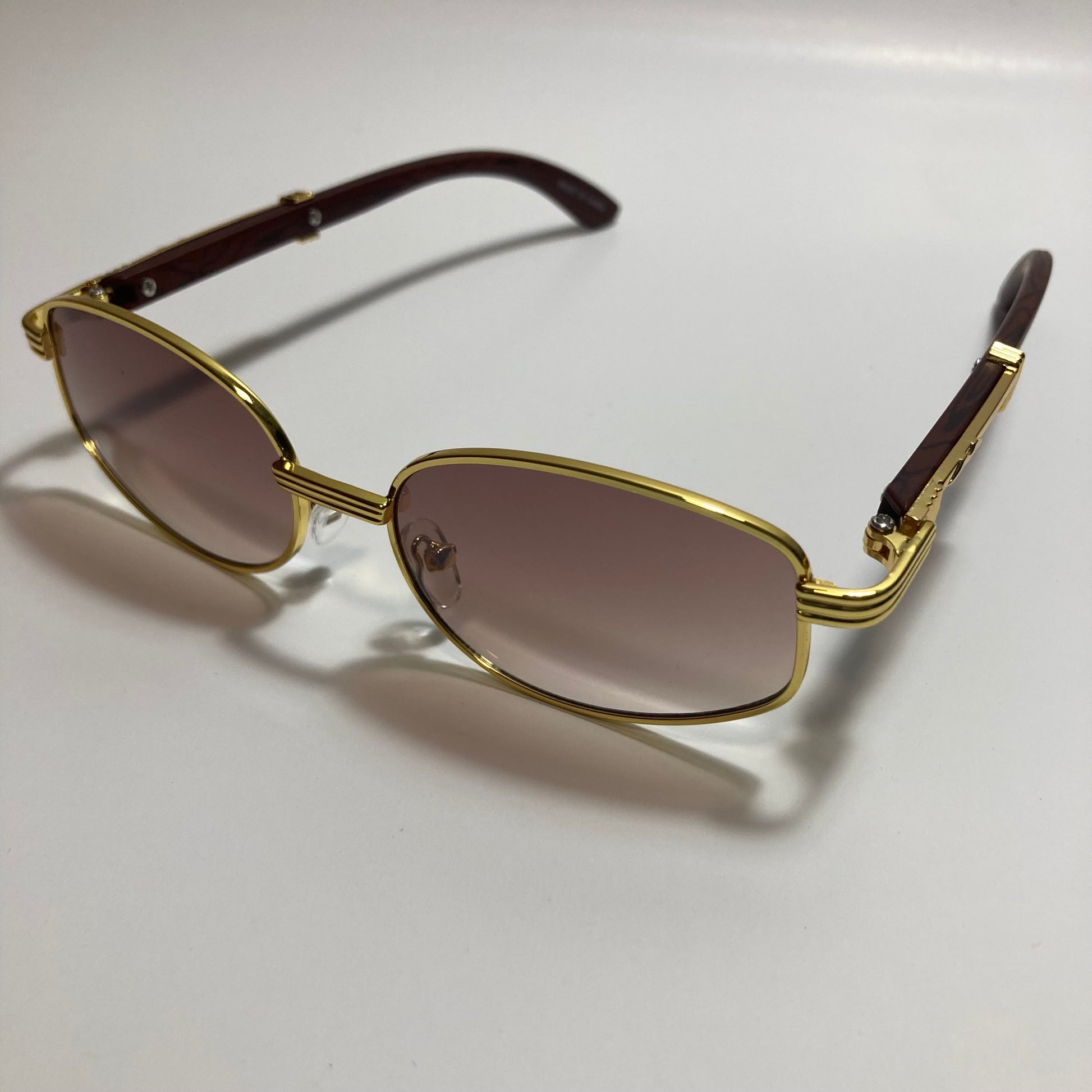 mens and womens brown and gold oval sunglasses