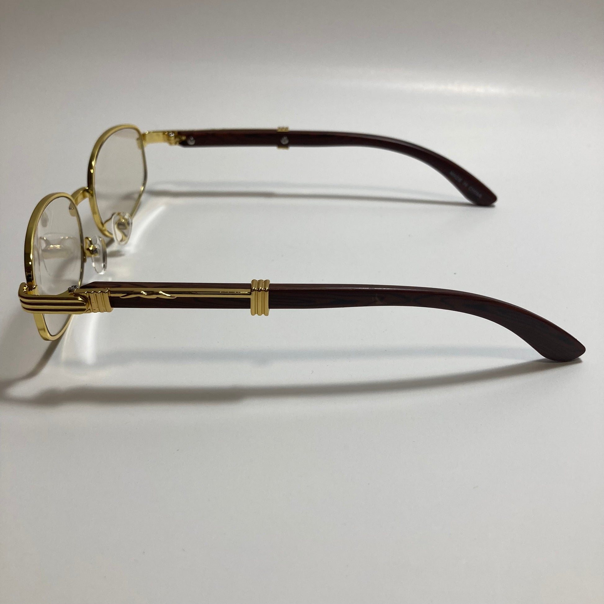 mens and womens clear and gold oval sunglasses