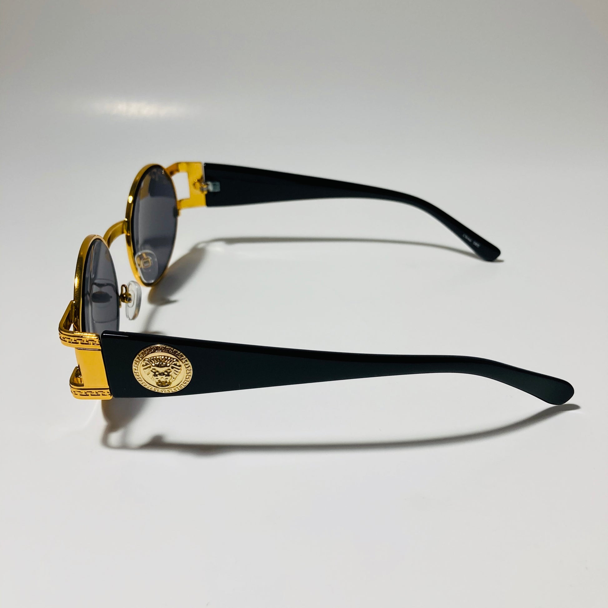 mens and womens black and gold round sunglasses
