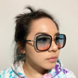 woman wearing elton john sunglasses